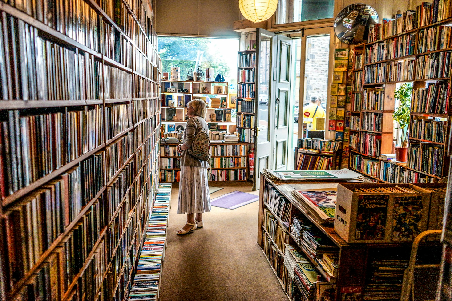 Image of a lady standing in a Bookshop